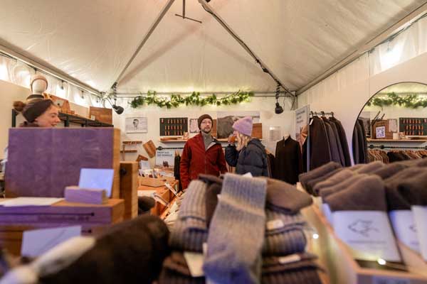 Wide-angle shot of a tent with lighting and wool products