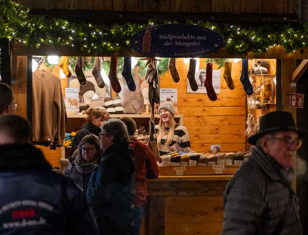 Christmas market stall where people are laughing