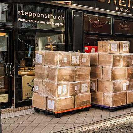 Two stacks of cardboard boxes in front of the steppenstrolch shop