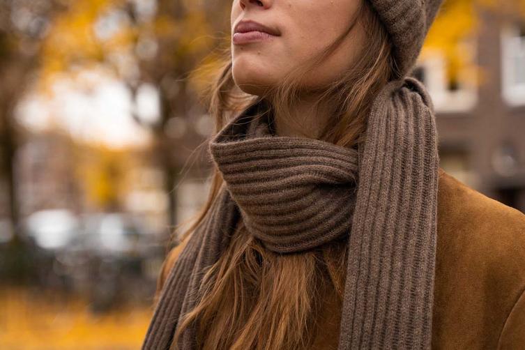 Woman wears brown scarf
